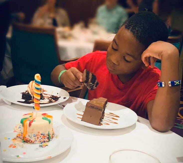 Boy with three desserts on cruise ship