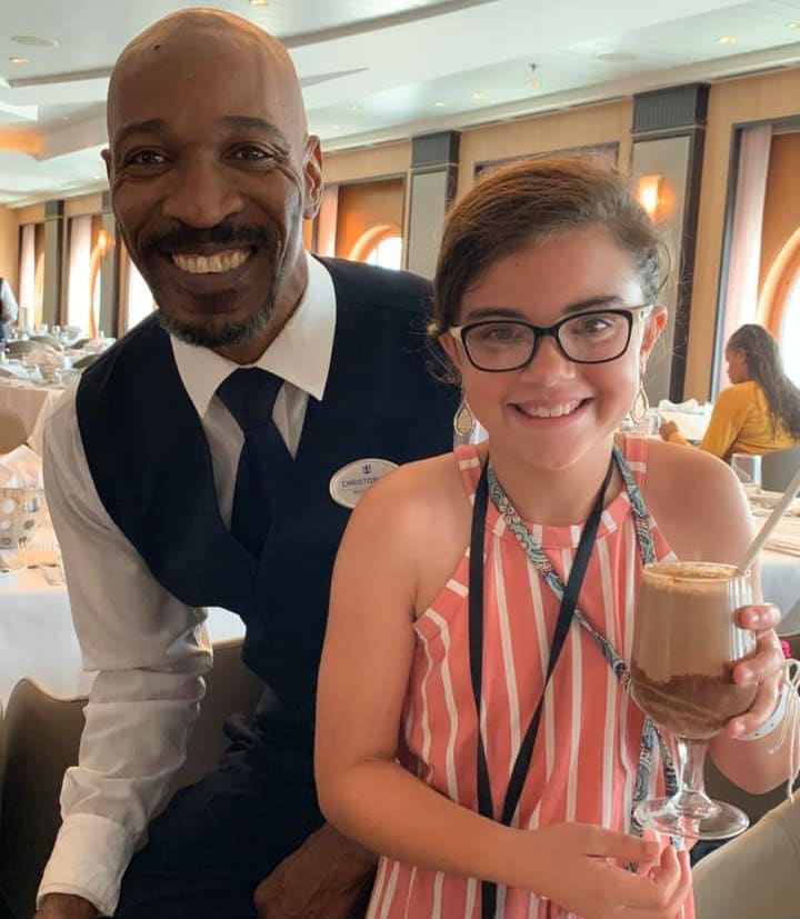 girl with waiter and chocolate milk in main dining room