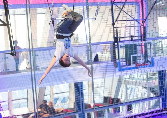A brave woman learning how to use the trapeze