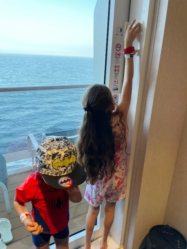 My kids opening the balcont door on MSC Virtuosa.