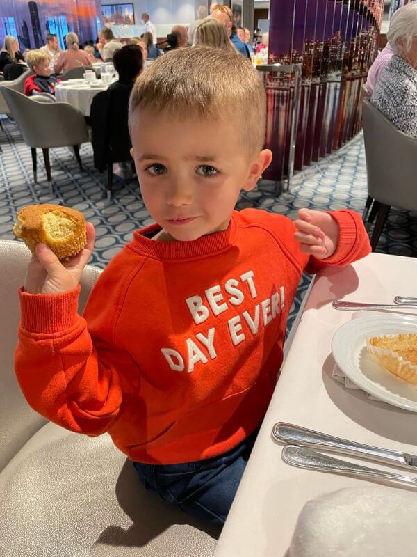 Adam eating a cupcake in the main dining room on Anthem of the Seas