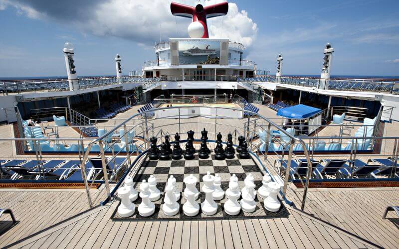 The seaside theatre of Carnival glory with an big chess board set as a center piece.