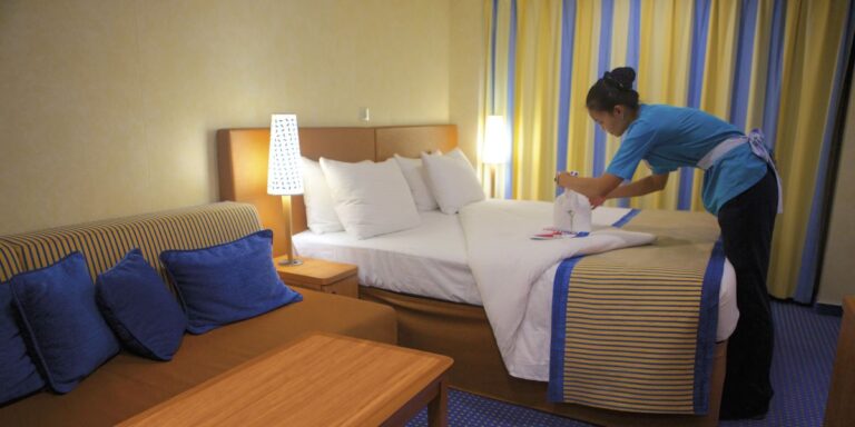 Carnival stateroom attendant working on towel animals