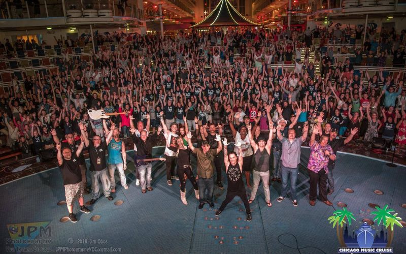 Performers on stage in front of a large crowd