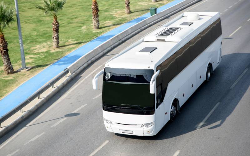 A aerieal view of a coach driving along a road.