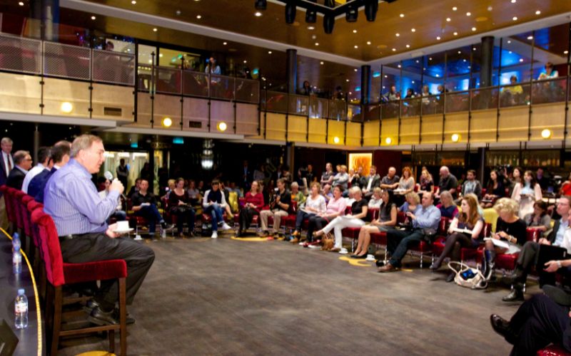 A guest of speaker speaking inside the cruise conference center