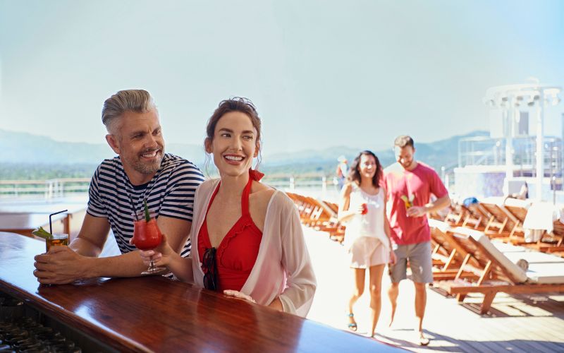 Couple enjoying cocktails on Cunard deck