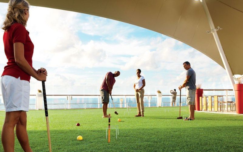 group of people playing croquet