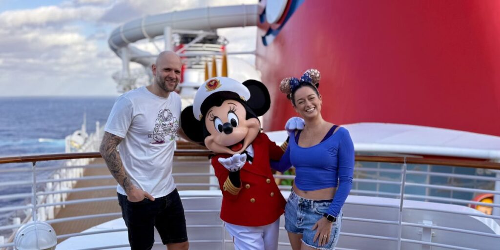 Me and my husband with Captain Minnie onbaord the Disney Wish