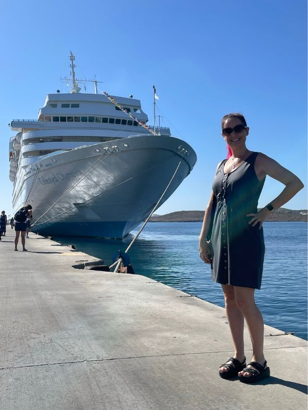 Woman standing in front of Celestyal Olympia cruise ship