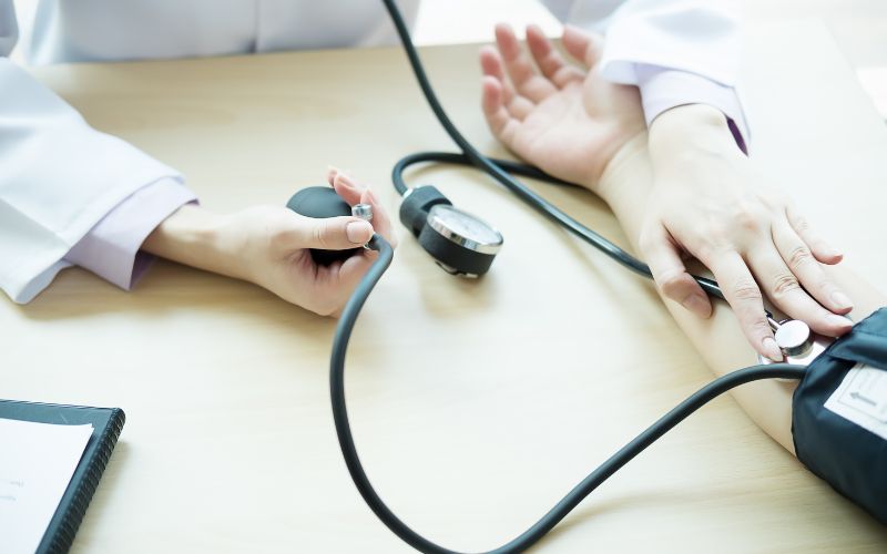 Doctor Measuring Patient Blood Pressure