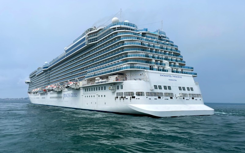 The Enchanted Princess cruise ship from Princess Cruises, showcased in the calm sea under an overcast sky.