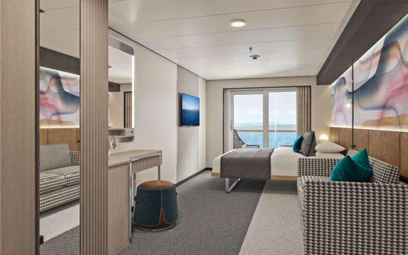 Contemporary family balcony stateroom on a cruise ship, featuring a houndstooth couch, a comfortable bed with teal pillows, a mounted flat-screen TV, and abstract wall art, with natural light streaming in from the ocean-view balcony.