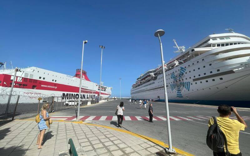 A small ferry and a medium sized cruise ship together