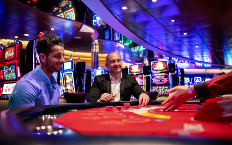 Men playing casino onboard Harmony of the Seas