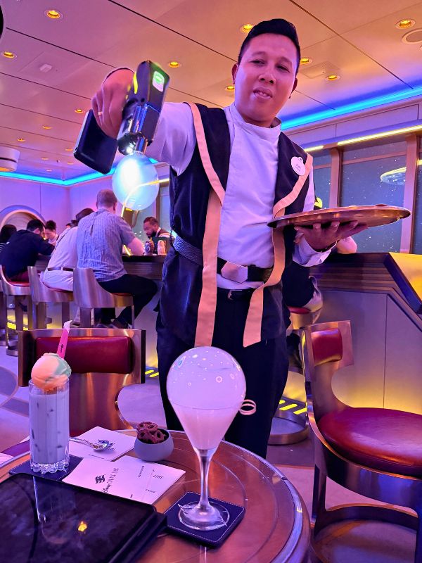 waiter making cocktails in Hyperspace Lounge on the Disney Wish