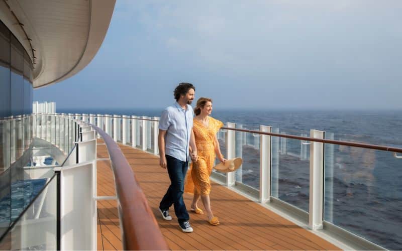 Two person walking happily on a cruise without feeling sick