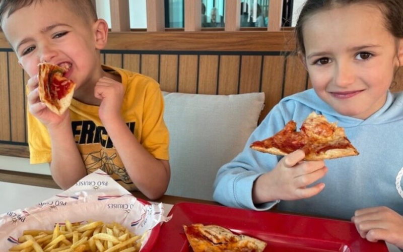 My children eating their pizza and fries