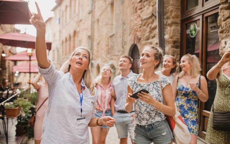 A group of people being showed around on a city tour.