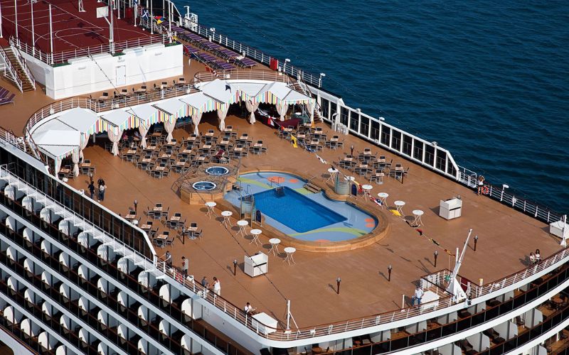 An outdoor swimming pool on the lido deck