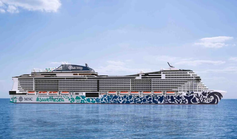 The MSC Euribia cruise ship adorned with #savethesea artwork floats on a calm blue sea under a clear sky, symbolizing maritime leisure and environmental awareness.