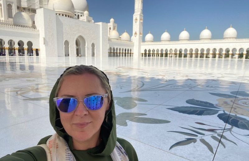Lady taking a picture on a muslim architecture
