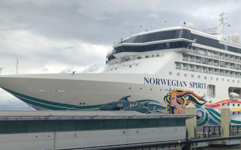 Norwegian Spirit cruise ship sailing on the ocean under clear blue skies.
