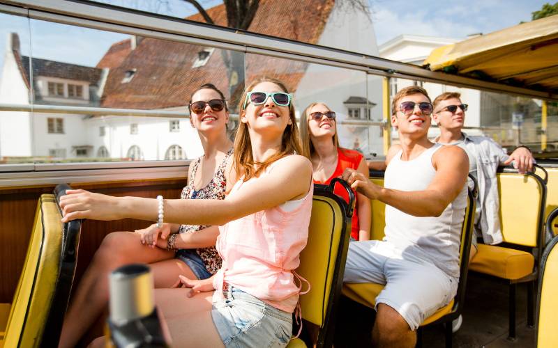 A group of people on an open top bus.