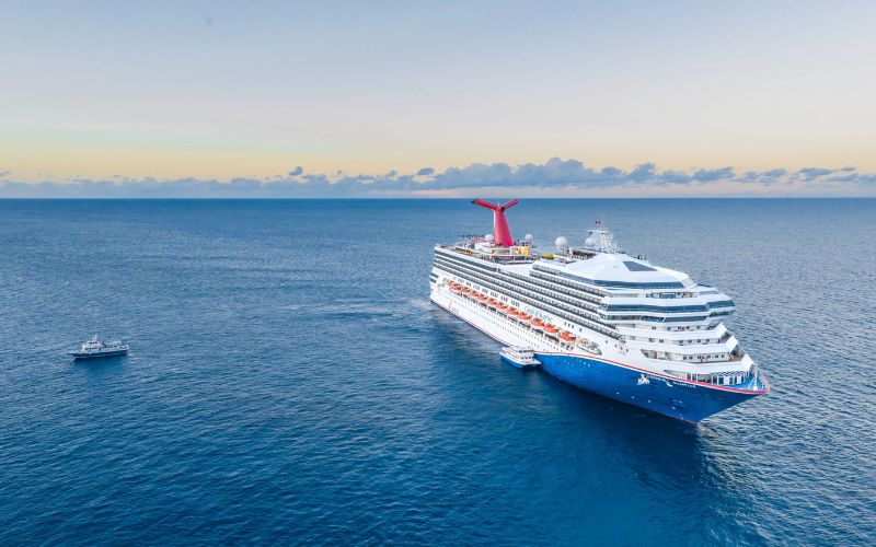 Carnival Sunrise and a tender boat at the ocean