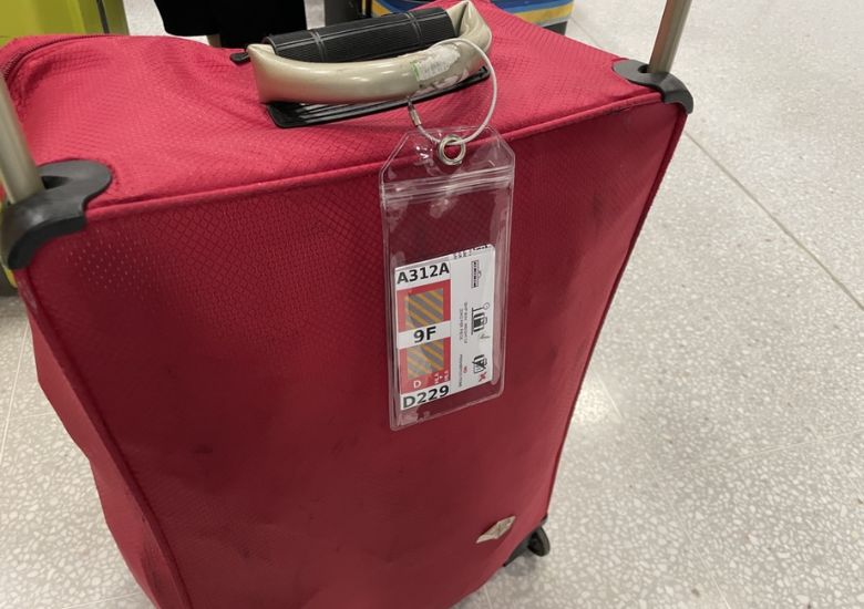 Red cruise luggage with tag
