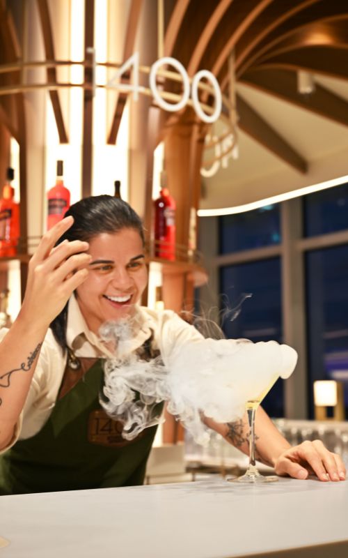 Royal caribbean bartender prepares a cool cocktail onboard