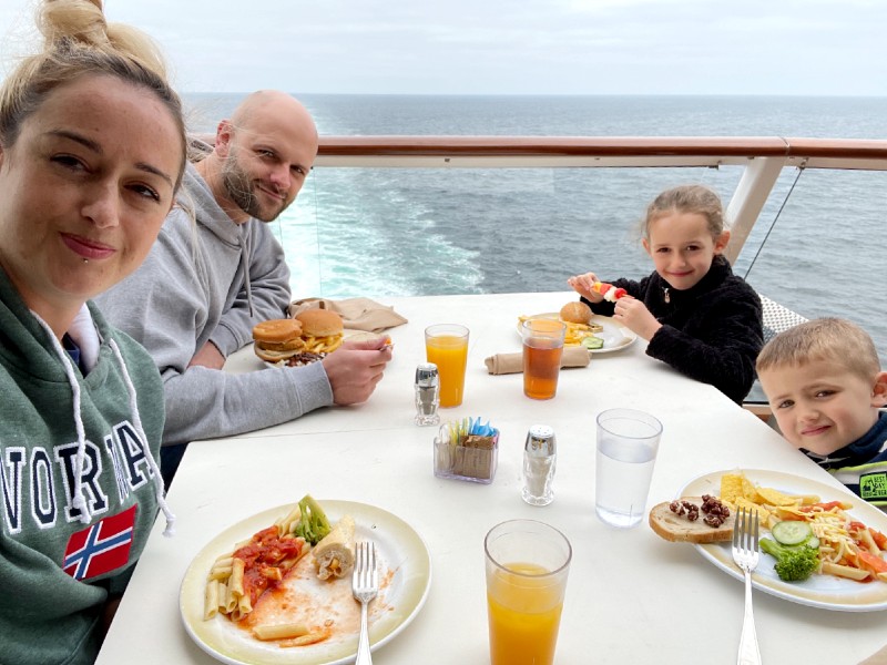 Family enjoying fresh juice al fresco on a cruise ship