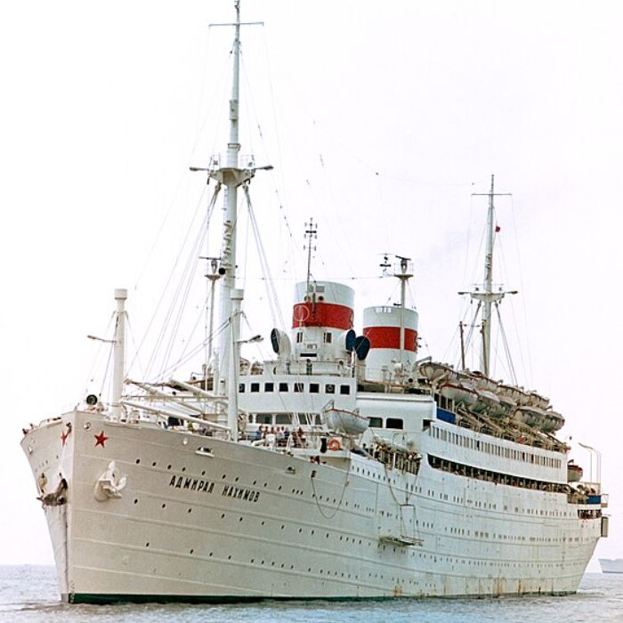 The SS Admiral Nakhimov, formerly a prominent Soviet passenger liner, shown with its classic white exterior, red and black funnel, and deck lined with lifeboats, representing the maritime history of the 20th century.