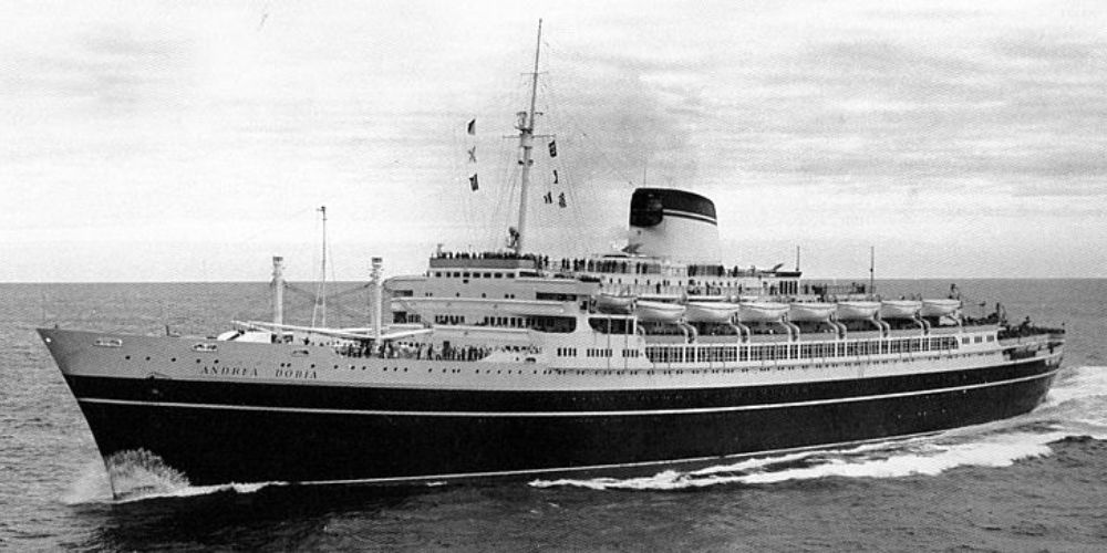 The SS Andrea Doria, an ocean liner, cruising on the high seas captured in a vintage black and white photo, showcasing its elegant design and the majesty of transatlantic travel in the mid-20th century.