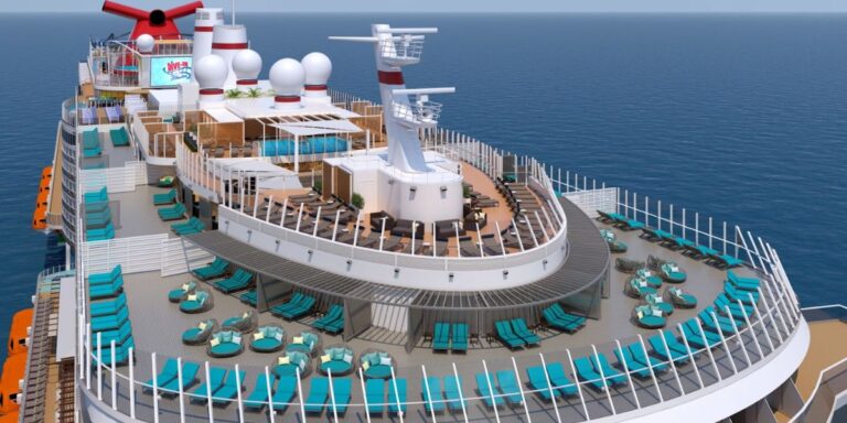 Aerial view of the Serenity adults-only retreat area on the Carnival Mardi Gras cruise ship, showcasing turquoise sun loungers, circular daybeds, a poolside bar, and the expansive open deck with the tranquil ocean in the background.