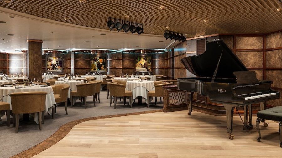 The Silver Note jazz club on a Silversea cruise ship, where soft lighting complements the warm beige tones of the room, a grand piano awaits its next performance, and elegant table settings invite guests for a night of music and dining.