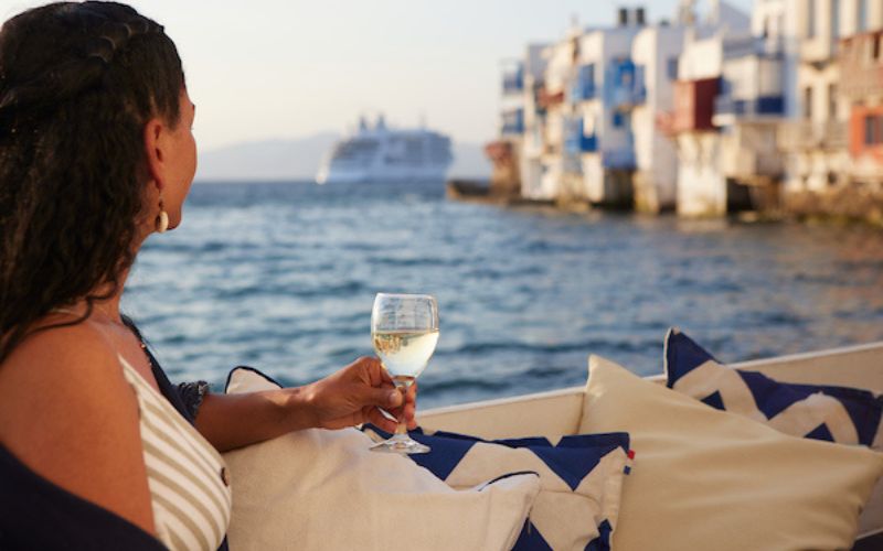 Silversea guest drinking white wine in Mykonos