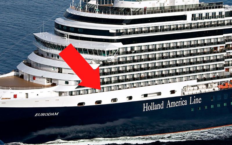 The aft section of the Holland America Line Eurodam cruise ship, with a large red arrow pointing to the steel balcony rails.