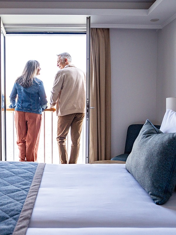 Couple relaxing on a balcony on a TUI River Cruise ship