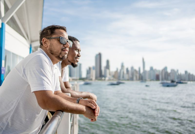 Two men on NCL cruise ship looking at the sea