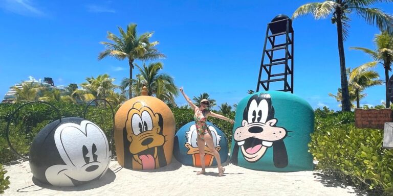 a woman at the beach with disney characters as background