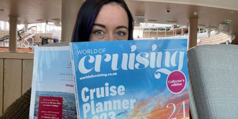 Cruise Mummy holding a copy of World Cruising's magazine