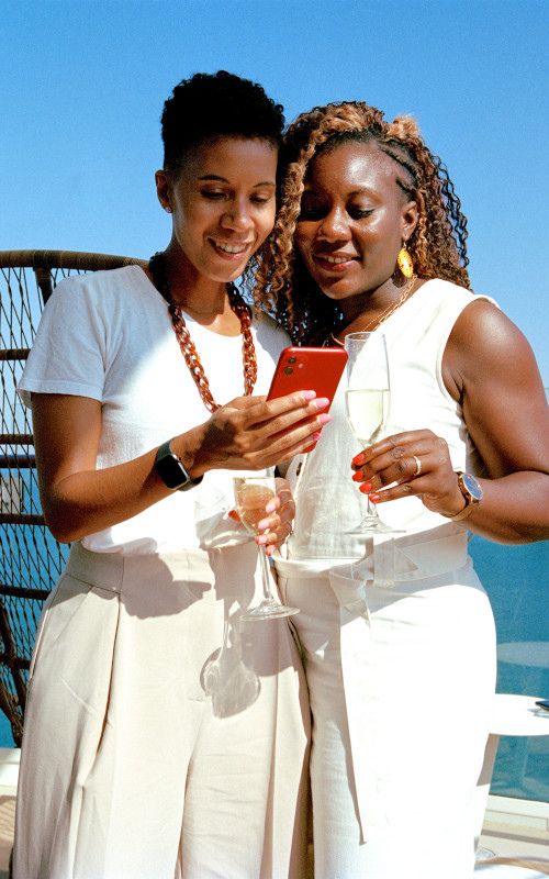 Two woman beside each other onboard while using the celebrity app without wifi