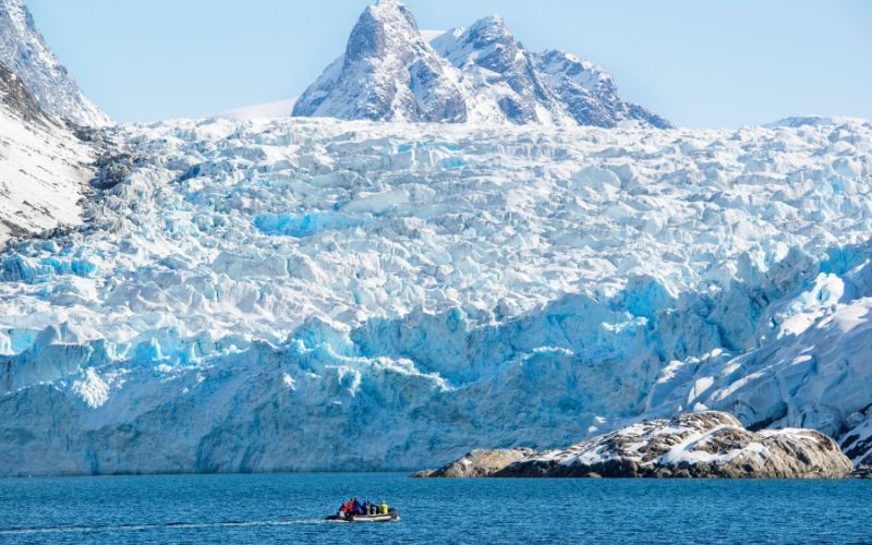 Zodiac boat in front of a glacier in Greenland