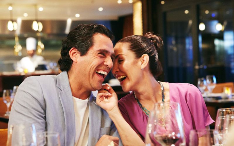 a couple enjoying dinner on honeymoon on a Carnival cruise