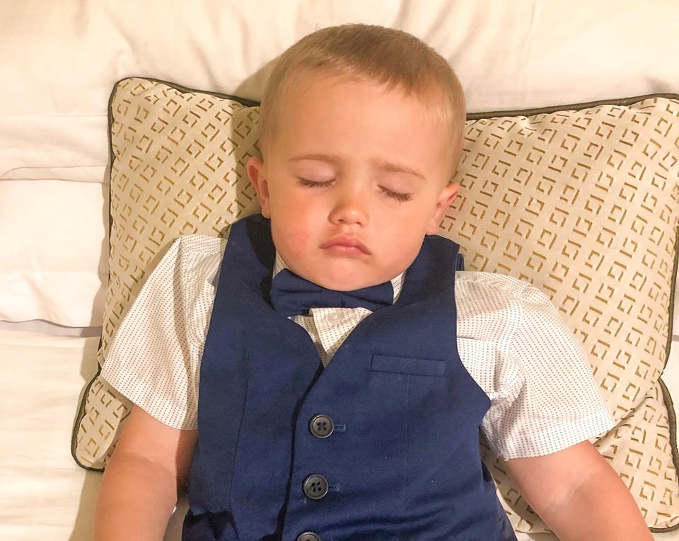 Child asleep in a tuxedo