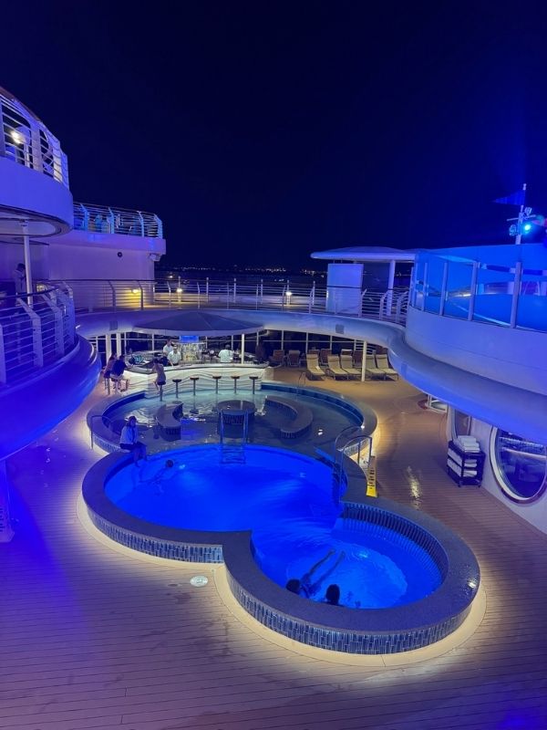 Adult pool at night on Disney Dream