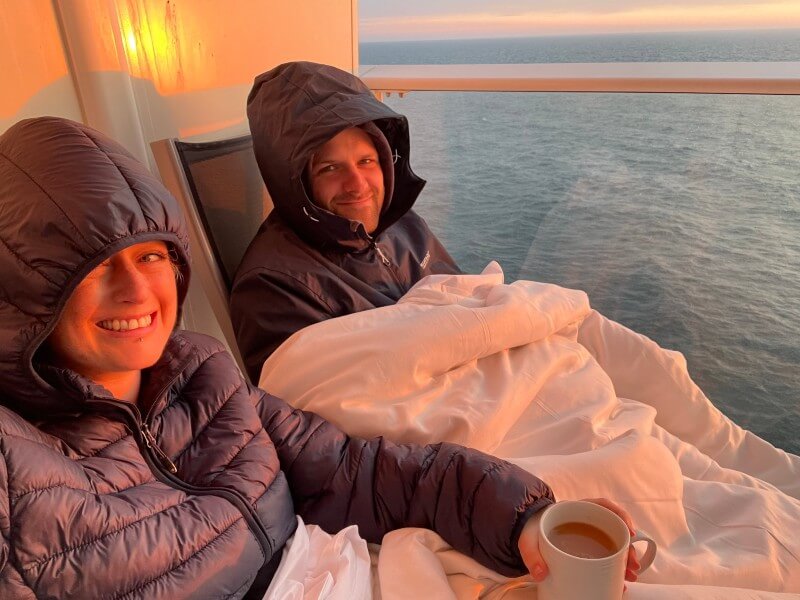 Sitting on a balcony in winter coats and duvet watching the sunset.