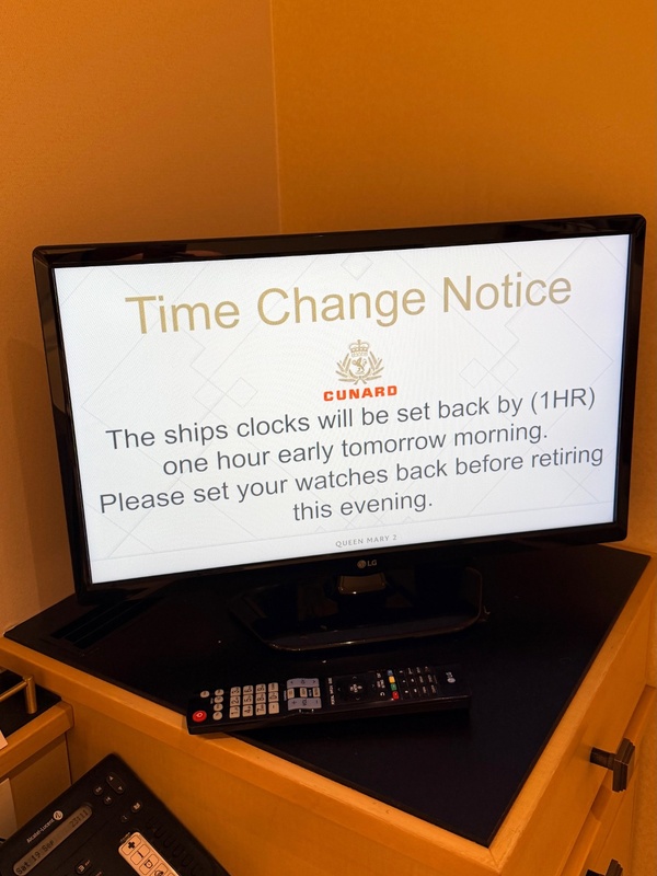 Cabin television displaying a notice that the ship’s clocks will go back one hour.