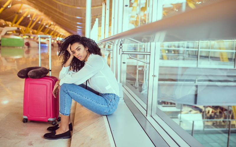 a woman in the cruise terminal whose cruise has been cancelled